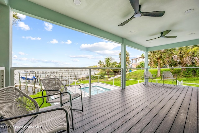 1313 Worth Ct NE, Palm Bay, FL 32905 - wooden terrace featuring ceiling fan, a lawn, and a swimming pool