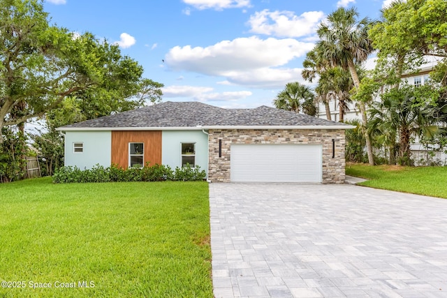 1313 Worth Ct NE, Palm Bay, FL 32905 - ranch-style house featuring decorative driveway, a front yard, a garage, stucco siding, and stone siding