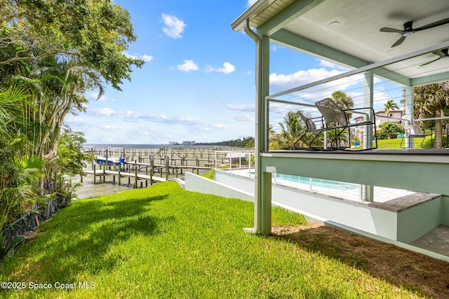 1313 Worth Ct NE, Palm Bay, FL 32905 - view of grassy yard featuring a ceiling fan, boat lift, and a boat dock