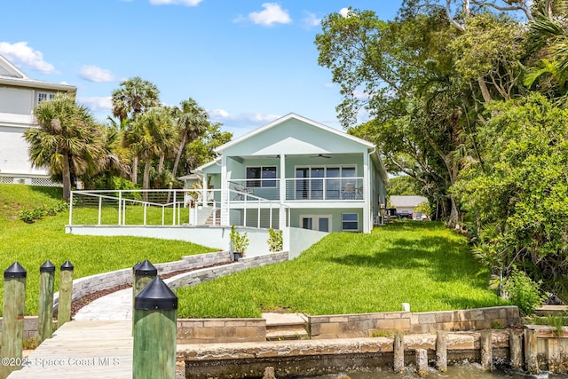 1313 Worth Ct NE, Palm Bay, FL 32905 - rear view of property with a yard, a ceiling fan, and a water view
