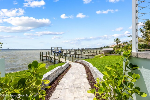 1313 Worth Ct NE, Palm Bay, FL 32905 - view of yard with boat lift, a dock, and a water view