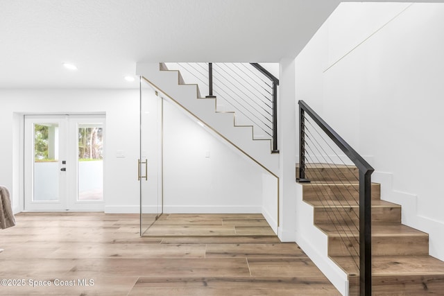 1313 Worth Ct NE, Palm Bay, FL 32905 - stairway featuring wood finished floors, recessed lighting, french doors, and baseboards