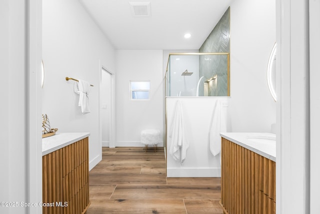 1313 Worth Ct NE, Palm Bay, FL 32905 - full bath with vanity, a shower with shower door, recessed lighting, wood finished floors, and baseboards