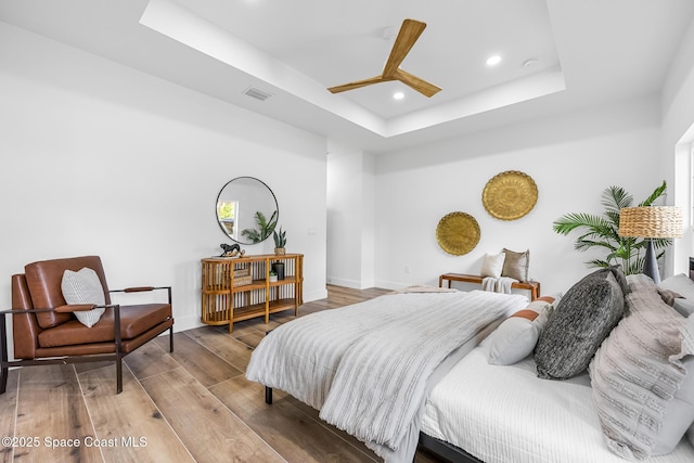 1313 Worth Ct NE, Palm Bay, FL 32905 - bedroom with a raised ceiling, recessed lighting, wood finished floors, baseboards, and a ceiling fan