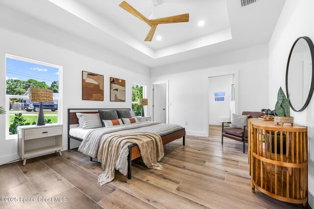 1313 Worth Ct NE, Palm Bay, FL 32905 - bedroom with a raised ceiling, light wood-type flooring, baseboards, recessed lighting, and ceiling fan