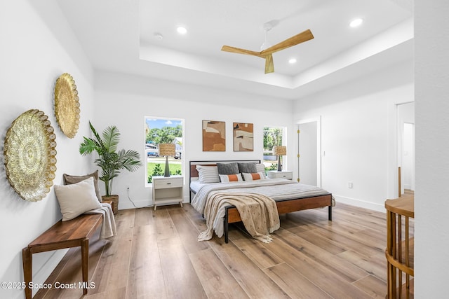 1313 Worth Ct NE, Palm Bay, FL 32905 - bedroom with a raised ceiling, light wood-style floors, recessed lighting, baseboards, and a ceiling fan