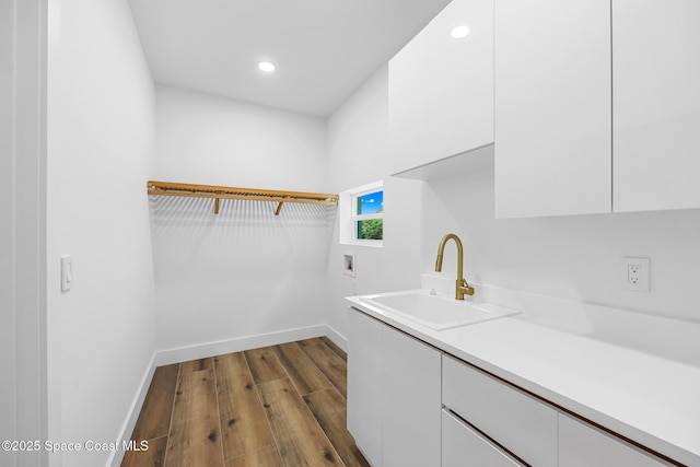 1313 Worth Ct NE, Palm Bay, FL 32905 - laundry area featuring hookup for a washing machine, dark wood-type flooring, cabinet space, baseboards, and recessed lighting