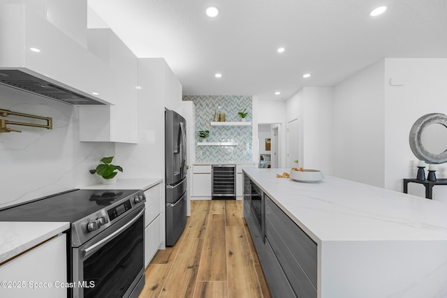 1313 Worth Ct NE, Palm Bay, FL 32905 - kitchen with stainless steel appliances, custom range hood, modern cabinets, open shelves, and white cabinetry