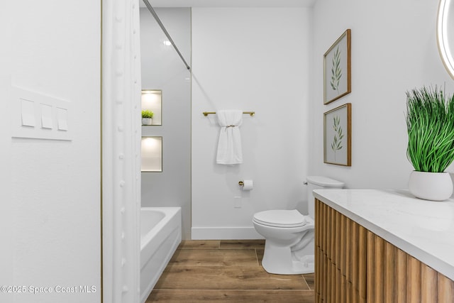 1313 Worth Ct NE, Palm Bay, FL 32905 - full bath with toilet, wood finished floors, baseboards, shower / bath combination, and vanity
