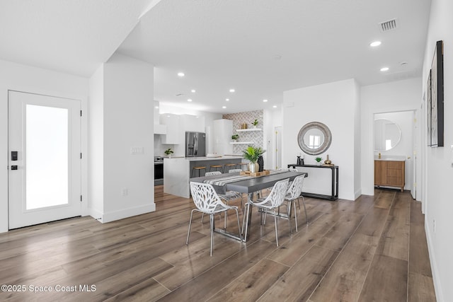 1313 Worth Ct NE, Palm Bay, FL 32905 - dining room with dark wood-style floors, recessed lighting, and baseboards