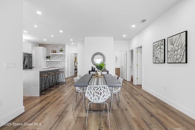 1313 Worth Ct NE, Palm Bay, FL 32905 - dining space featuring recessed lighting, light wood-style floors, and baseboards
