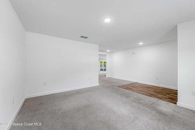 2205 Sapelo Ave SE, Palm Bay, FL 32909 - spare room with carpet flooring, recessed lighting, and baseboards