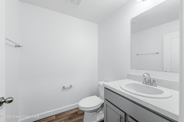 2205 Sapelo Ave SE, Palm Bay, FL 32909 - half bath with vanity, wood finished floors, toilet, and baseboards