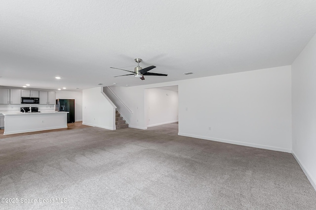 2205 Sapelo Ave SE, Palm Bay, FL 32909 - unfurnished living room with recessed lighting, light carpet, stairway, a ceiling fan, and baseboards