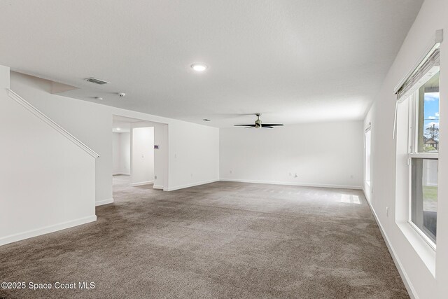 2205 Sapelo Ave SE, Palm Bay, FL 32909 - unfurnished living room featuring ceiling fan, carpet, recessed lighting, and baseboards