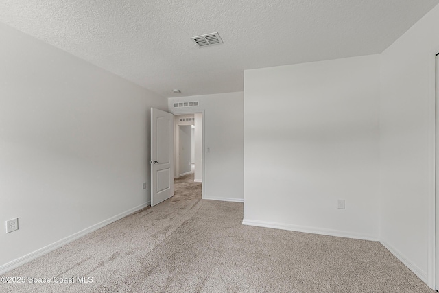 2205 Sapelo Ave SE, Palm Bay, FL 32909 - carpeted spare room with baseboards and a textured ceiling