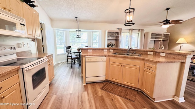 803 Crossbow Dr, West Melbourne, FL 32904 - kitchen with white appliances, light brown cabinets, a sink, light wood-type flooring, and a textured ceiling