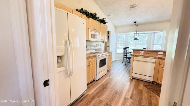 803 Crossbow Dr, West Melbourne, FL 32904 - kitchen with white appliances, vaulted ceiling, a textured ceiling, light wood-style floors, and light brown cabinetry
