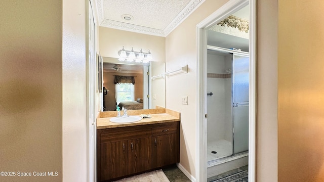 803 Crossbow Dr, West Melbourne, FL 32904 - ensuite bathroom with ornamental molding, vanity, a stall shower, and a textured ceiling