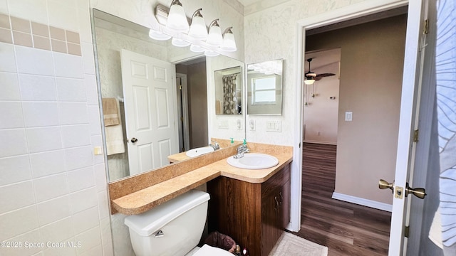 803 Crossbow Dr, West Melbourne, FL 32904 - bathroom with wood finished floors, vanity, baseboards, toilet, and ceiling fan
