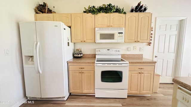 803 Crossbow Dr, West Melbourne, FL 32904 - kitchen with white appliances, light wood-type flooring, light brown cabinetry, and light countertops