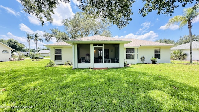 803 Crossbow Dr, West Melbourne, FL 32904 - rear view of property with a lawn, a sunroom, and stucco siding