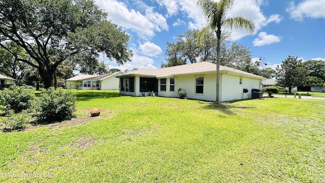 803 Crossbow Dr, West Melbourne, FL 32904 - rear view of property with central air condition unit, a yard, a sunroom, and stucco siding