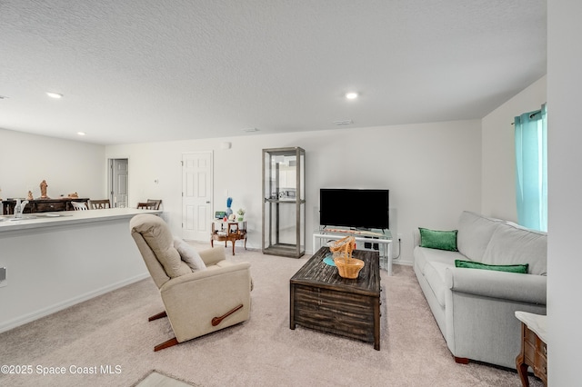 499 Grenadier Ave NW, Palm Bay, FL 32907 - living area with recessed lighting, light colored carpet, a textured ceiling, and baseboards