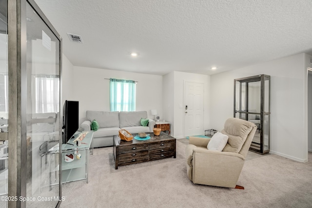 499 Grenadier Ave NW, Palm Bay, FL 32907 - carpeted living room featuring a textured ceiling, recessed lighting, and baseboards
