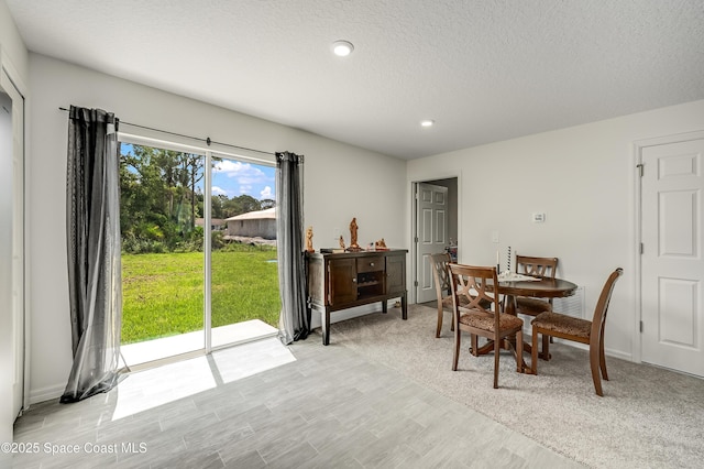 499 Grenadier Ave NW, Palm Bay, FL 32907 - dining space featuring light wood-type flooring, recessed lighting, and a textured ceiling