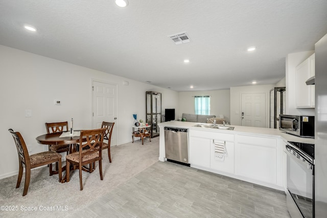 499 Grenadier Ave NW, Palm Bay, FL 32907 - kitchen with appliances with stainless steel finishes, a peninsula, a sink, white cabinets, and light countertops