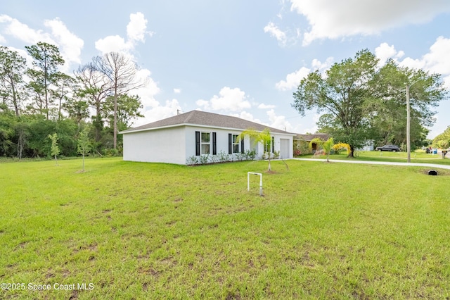 499 Grenadier Ave NW, Palm Bay, FL 32907 - single story home featuring a garage, a front yard, and stucco siding