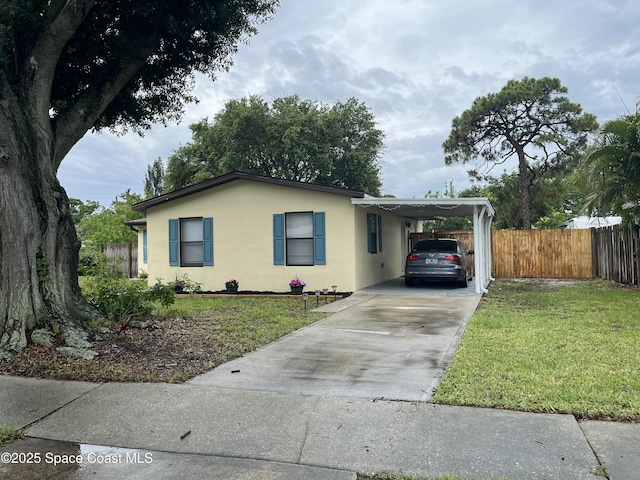 1148 Indrio Ln NE, Palm Bay, FL 32905 - view of front of house featuring stucco siding, driveway, and a carport