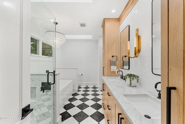 4185 Crooked Mile Rd, Merritt Island, FL 32952 - full bathroom with double vanity, a chandelier, a shower stall, a freestanding bath, and baseboards