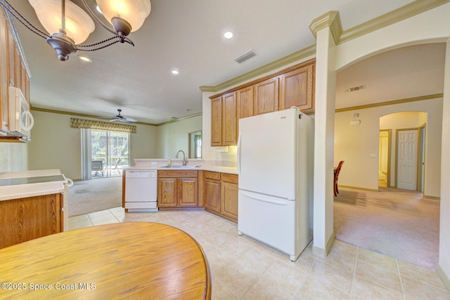 858 Morning Cove Cir SE, Palm Bay, FL 32909 - kitchen featuring white appliances, light colored carpet, a sink, light tile patterned floors, and arched walkways