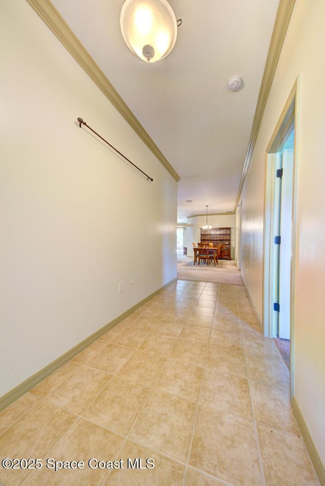 858 Morning Cove Cir SE, Palm Bay, FL 32909 - hall featuring crown molding, light tile patterned flooring, and baseboards