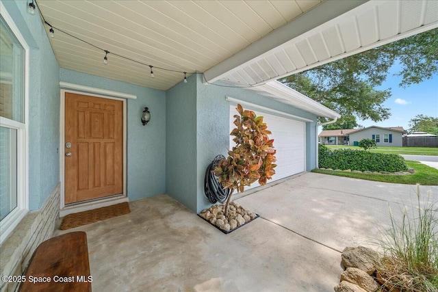 609 Tallwood Cir, Melbourne, FL 32904 - doorway to property featuring stucco siding and an attached garage