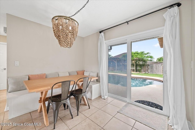 609 Tallwood Cir, Melbourne, FL 32904 - dining area with a chandelier and light tile patterned floors