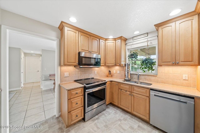 609 Tallwood Cir, Melbourne, FL 32904 - kitchen with appliances with stainless steel finishes, a sink, tasteful backsplash, recessed lighting, and light stone counters