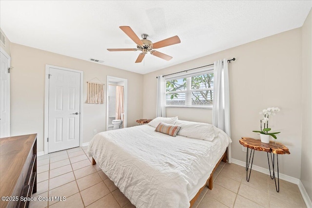 609 Tallwood Cir, Melbourne, FL 32904 - bedroom featuring light tile patterned floors, baseboards, a ceiling fan, and ensuite bath