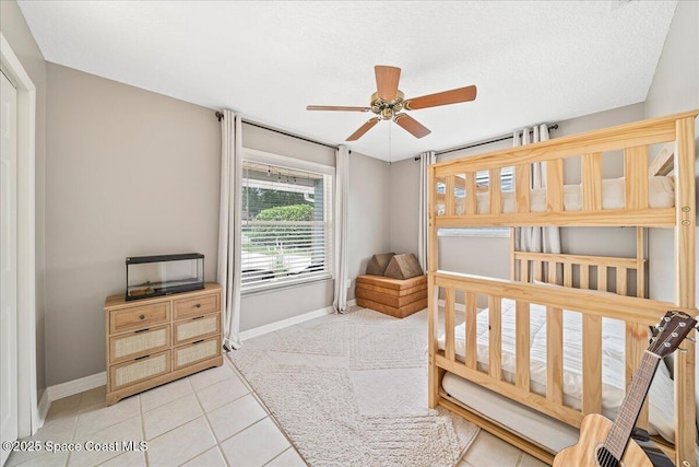 609 Tallwood Cir, Melbourne, FL 32904 - bedroom with baseboards, tile patterned flooring, and a ceiling fan