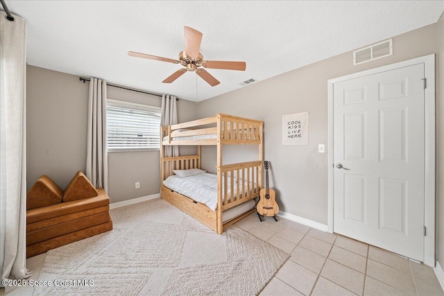 609 Tallwood Cir, Melbourne, FL 32904 - tiled bedroom with baseboards and a ceiling fan