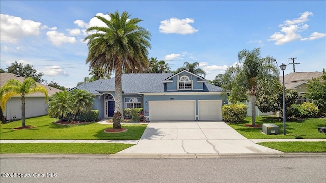 2465 Tuscarora Ct, Melbourne, FL 32904 - view of front of house with concrete driveway, a front yard, and stucco siding