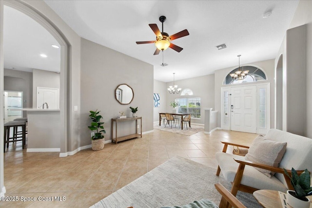 2465 Tuscarora Ct, Melbourne, FL 32904 - foyer featuring a chandelier, arched walkways, light tile patterned floors, and baseboards