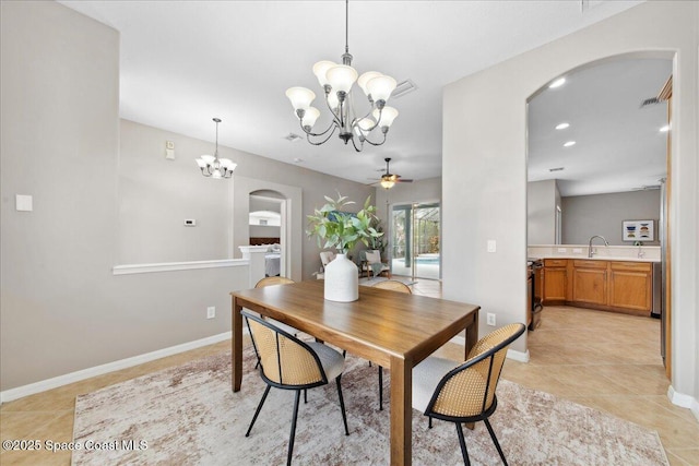 2465 Tuscarora Ct, Melbourne, FL 32904 - dining space with arched walkways, a chandelier, a ceiling fan, light tile patterned floors, and baseboards
