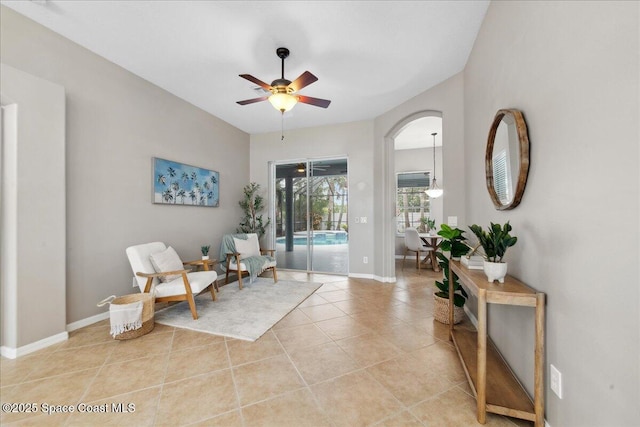2465 Tuscarora Ct, Melbourne, FL 32904 - living area with ceiling fan, light tile patterned floors, baseboards, and arched walkways