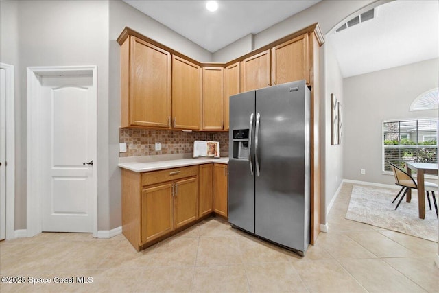 2465 Tuscarora Ct, Melbourne, FL 32904 - kitchen featuring stainless steel fridge, backsplash, light countertops, light tile patterned floors, and baseboards