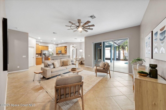 2465 Tuscarora Ct, Melbourne, FL 32904 - living area featuring light tile patterned flooring, a ceiling fan, and baseboards