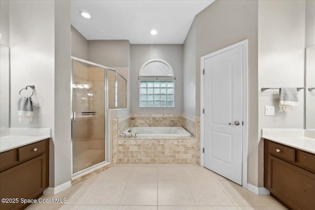 2465 Tuscarora Ct, Melbourne, FL 32904 - bathroom featuring a garden tub, a shower stall, vanity, and tile patterned flooring