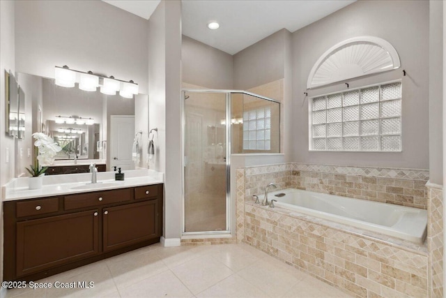 2465 Tuscarora Ct, Melbourne, FL 32904 - bathroom with vanity, a garden tub, a shower stall, and tile patterned flooring